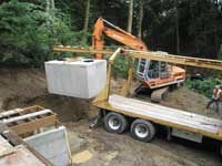 Excavator lowering the cistern